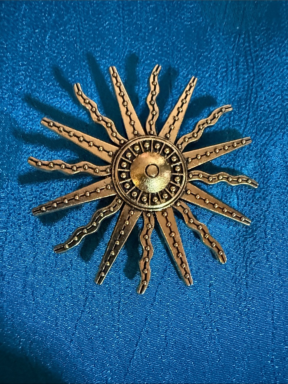 Sunburst Metal brooch in gold tone